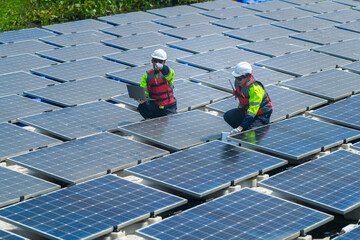 Photovoltaic engineers work on floating photovoltaics. workers Inspect and repair the solar panel equipment floating on water. Engineer working setup Floating solar panels Platform system on the lake.