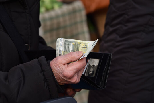 Zagreb, Croatia : 01, 05, 2024 : Close-up of paying  with euros at the vegetable market in Zagreb.