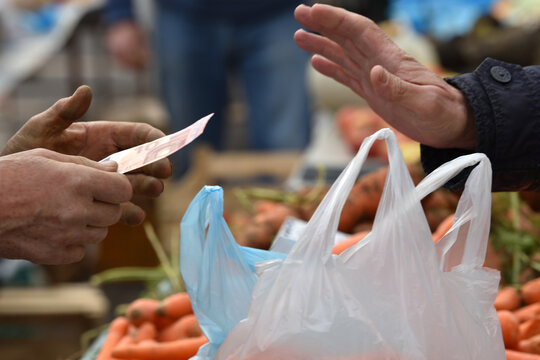 Zagreb, Croatia : 01, 05, 2024 : Close-up of paying  with euros at the vegetable market in Zagreb.