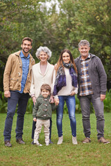 Family, grandparents and parents with child in portrait for bonding, happiness and picture in park. Outdoor, nature and old people with mother or father and kid for weekend or holiday together