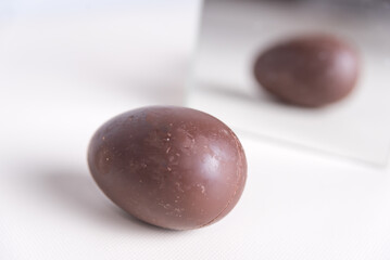 Sequence of a woman molding chocolate Easter eggs in her kitchen. melted chocolate, spice event, home, lifestyle concept