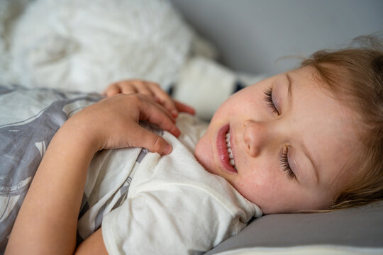 Cute little girl sleeping and grinding teeth in dreams, clenched teeth with tiredness and stress 
