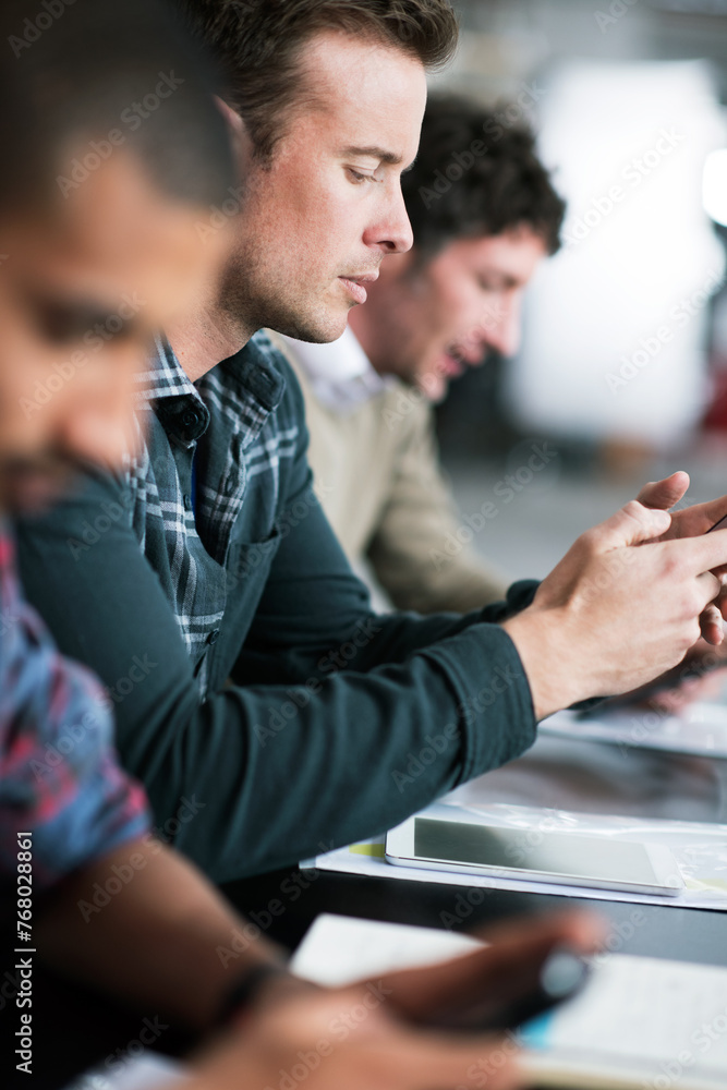 Poster Man, typing and meeting in office with phone research or communication of project with notes in email. Professional, team and person planning schedule with smartphone or reading online information