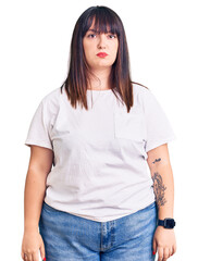 Young plus size woman wearing casual clothes depressed and worry for distress, crying angry and...