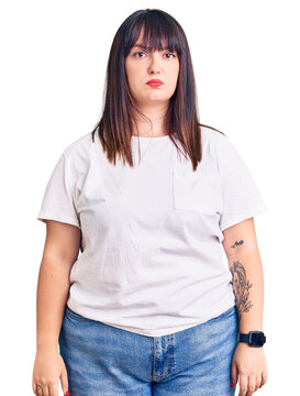 Young plus size woman wearing casual clothes depressed and worry for distress, crying angry and afraid. sad expression.