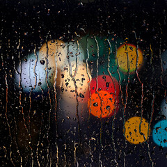 Rainy Wet Window at Night with Water Drops and City Lights