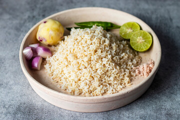 primitive food Brown cooked rice with potato paste fresh lemon and chilli. 