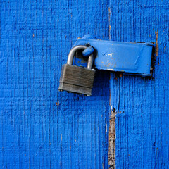 Lock on Hinge on Blue Door and Wall