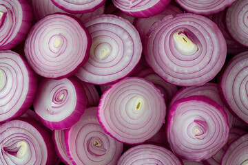 Closeup view of a pile of red onions, one sliced in half, showcasing vibrant colors and textures