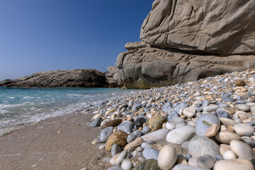 Amazing Seychelles beach with pebbles and crystal clear water, Ikaria island, Greece
