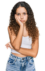 Teenager hispanic girl wearing casual clothes thinking looking tired and bored with depression problems with crossed arms.