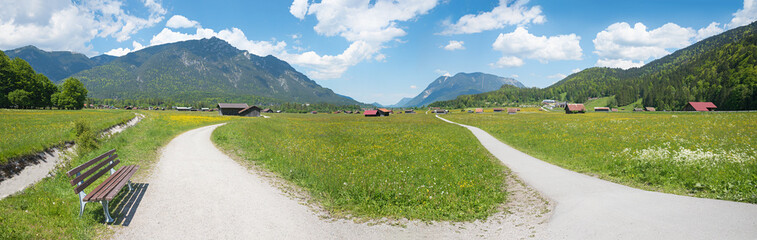 bike and hike route through rural landscape with huts and buttercup meadows, upper bavaria