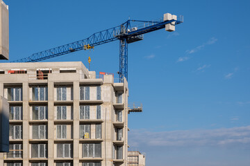 Windows installing Building work on the construction site in Europe. Modern Apartments Facade with windows. Not finished Architecture. growing building construction site