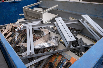 Construction debris in a container, disassembly of electrical communications. House renovation.