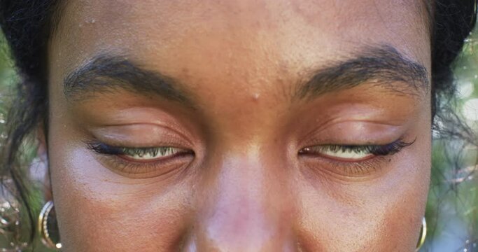 A close-up reveals a young African American woman's eyes