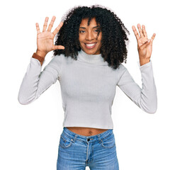 Young african american girl wearing casual clothes showing and pointing up with fingers number nine...
