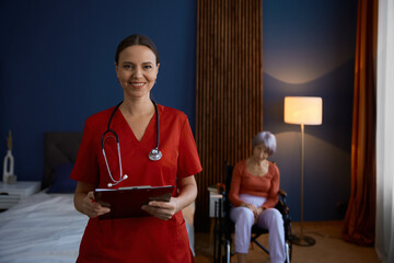 Friendly smiling woman doctor or nurse at nursing home - obrazy, fototapety, plakaty