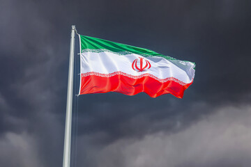 Flag of Iran waving in the wind against the dark sky..Iran national flag waving in the dark cloudy sky - 768041471