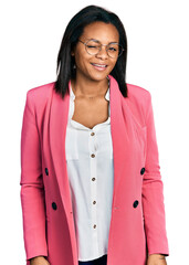 Beautiful hispanic woman wearing business jacket winking looking at the camera with sexy...