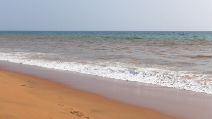 Fototapeta na wymiar The foam of turbulent wave on the beach at Veli, Thiruvananthapuram, Kerala, India