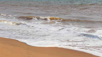 The foam of turbulent wave on the beach at Veli, Thiruvananthapuram, Kerala, India