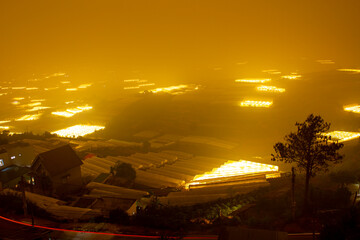 Fototapeta na wymiar Aerial View Of Greenhouses In Da Lat City On A Foggy Night, Vietnam.
