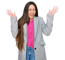 Young hispanic girl wearing business clothes celebrating mad and crazy for success with arms raised...