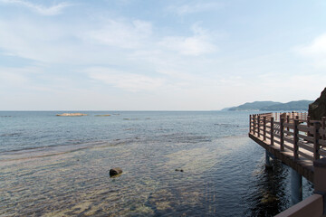 View of the seaside with the wooden footbridge