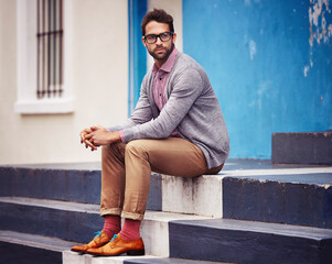 Man, building and relax on stairs for fashion, clothes and trendy with glasses outdoor in Cape...
