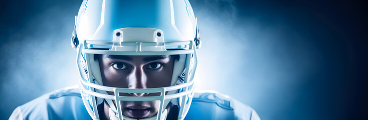 Portrait of American unrecognizable football player in helmet ready for attack game against blue foggy background, full of negative copy space, banner header advertisement