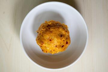Delicious Aloo Bharta on a white bowl. It is traditional Bengali (Bangladeshi) food. Top view. 