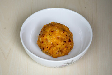 Delicious Aloo Bharta on a white bowl. It is traditional Bengali (Bangladeshi) food. It is known for its simplicity and flavorful taste.