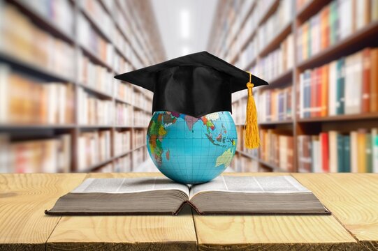 Graduation cap and books in universities library