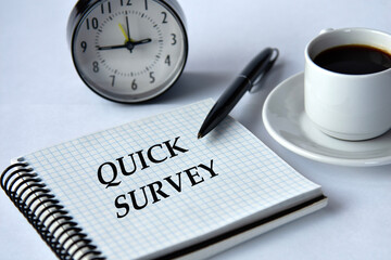 QUICK SURVEY - words in a notebook on a white background with a clock and a cup of coffee