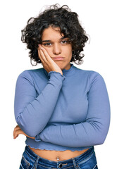 Fototapeta na wymiar Young hispanic woman with curly hair wearing casual clothes thinking looking tired and bored with depression problems with crossed arms.