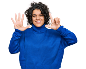 Young hispanic woman with curly hair wearing turtleneck sweater showing and pointing up with fingers number seven while smiling confident and happy.