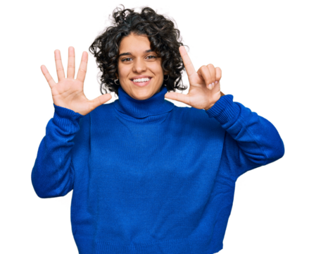 Young hispanic woman with curly hair wearing turtleneck sweater showing and pointing up with fingers number seven while smiling confident and happy.