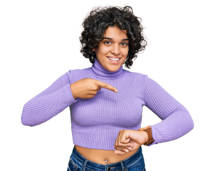 Young hispanic woman with curly hair wearing casual clothes in hurry pointing to watch time, impatience, upset and angry for deadline delay