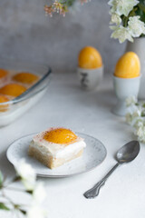 Homemade German Fried Egg Cake Spiegeleierkuchen (Spiegeleiertorte) with apricot and coconut milk pudding. Traditional Easter Dessert. Festive Easter food.