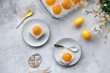 Homemade German Fried Egg Cake Spiegeleierkuchen (Spiegeleiertorte) with apricot and coconut milk pudding. Traditional Easter Dessert. Festive Easter food.