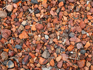 Red and grey rocks on ground