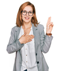 Young caucasian woman wearing business style and glasses smiling swearing with hand on chest and...