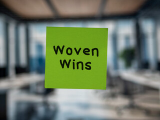 Post note on glass with 'Woven Wins'.