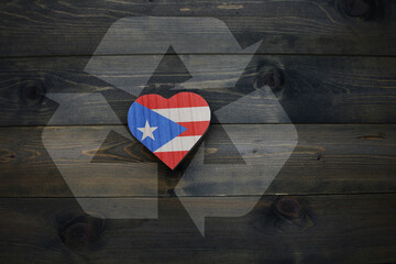 wooden heart with national flag of puerto rico near reduce, reuse and recycle sing on the wooden...