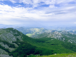 Naklejka na ściany i meble Lovcen national park aerial landscape with clouds in the mountains at summer view