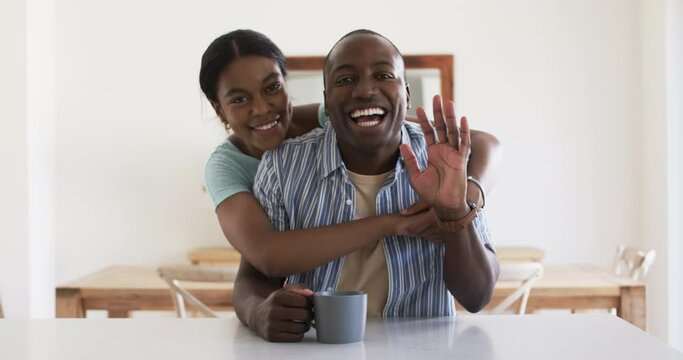 A young African American couple shares a joyful moment at home