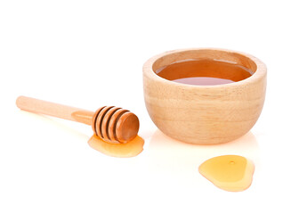 Honey in wood bowl and honey Dipper isolated on white background.