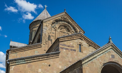 Fototapeta na wymiar Tourists in front of Svetitskhoveli - Cathedral of the Living Pillar in Mtskheta city, Mtskheta-Mtianeti region, Georgia