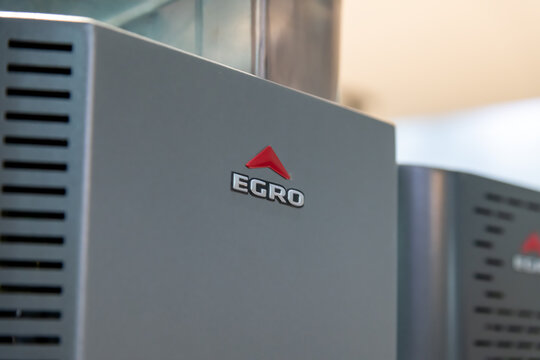 Russia, Moscow - October 03, 2023: Close-up view of Egro logo hanging on gray surface of bean-to-cup coffee vendinga machine. Illustrative editorial. Soft focus. Food and drink industry theme.