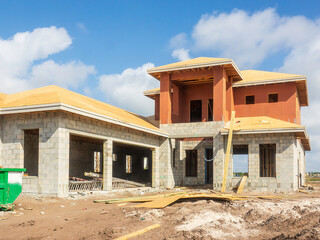 Upscale bi-level single-family house, with two-car garage, under construction in a suburban...